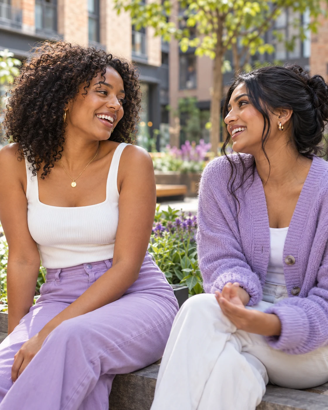 Two young adult friends chatting together outdoors